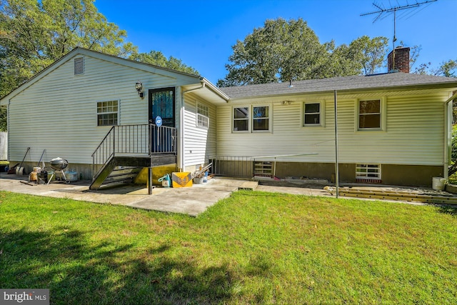 rear view of property with a patio and a yard