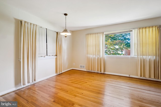 unfurnished room featuring hardwood / wood-style floors