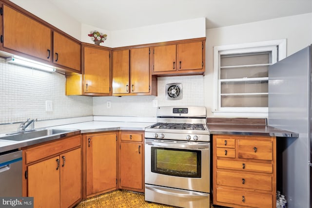 kitchen featuring stainless steel appliances, tasteful backsplash, and sink