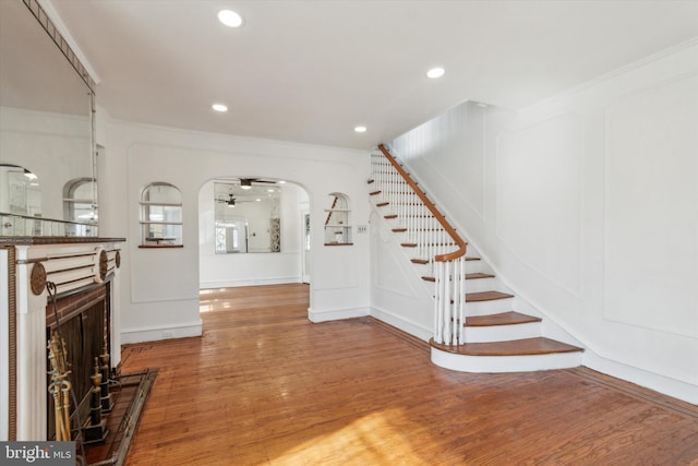 interior space featuring ornamental molding, ceiling fan, and hardwood / wood-style floors