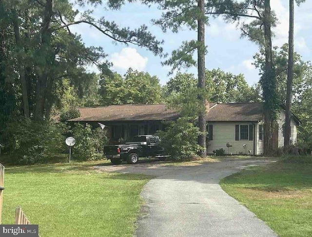 view of front facade with a carport and a front lawn