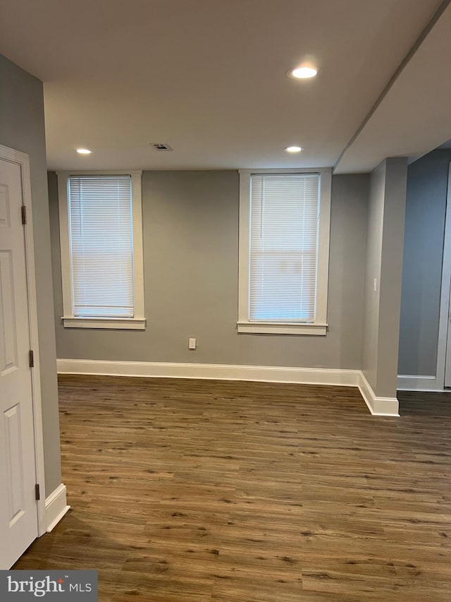 empty room with dark hardwood / wood-style floors