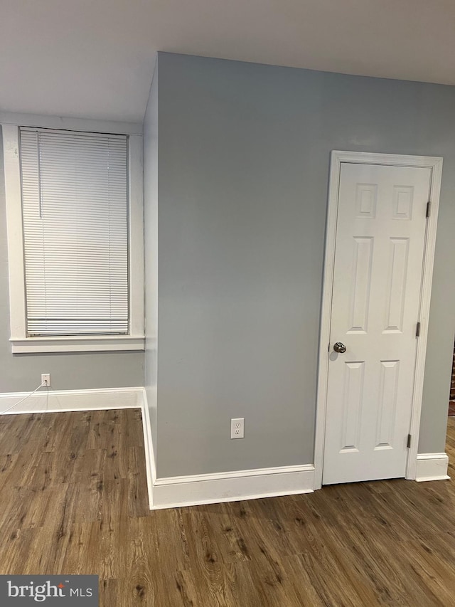 empty room featuring dark wood-type flooring