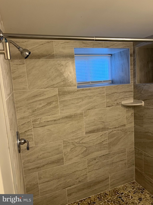 bathroom with tiled shower