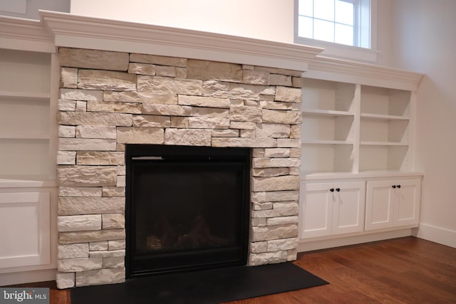 details featuring a stone fireplace and hardwood / wood-style floors