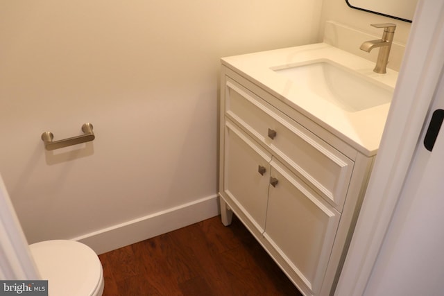 bathroom featuring hardwood / wood-style floors, vanity, and toilet