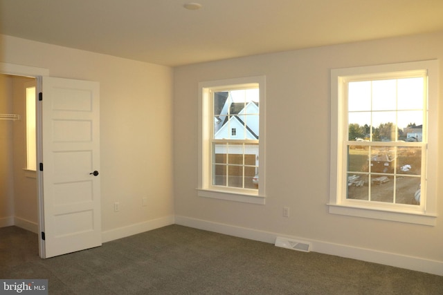 empty room with dark colored carpet