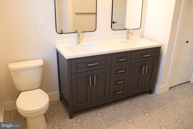 bathroom with tile patterned floors, vanity, and toilet