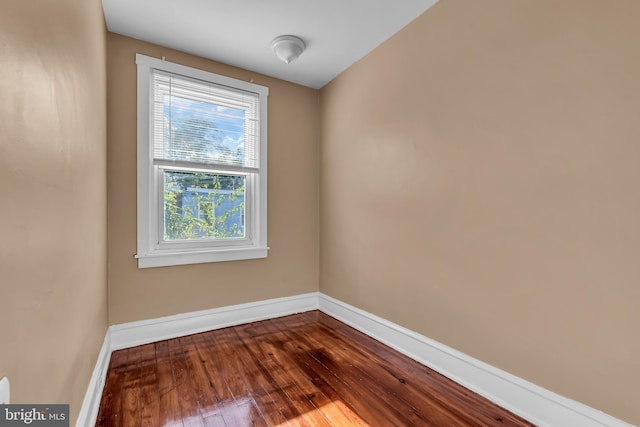 unfurnished room with wood-type flooring