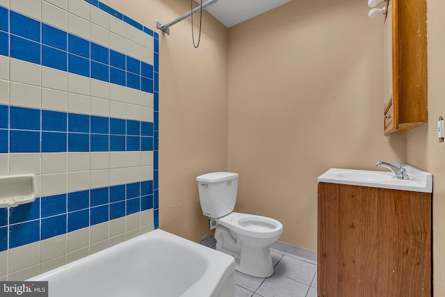 full bathroom with tiled shower / bath, vanity, toilet, and tile patterned flooring