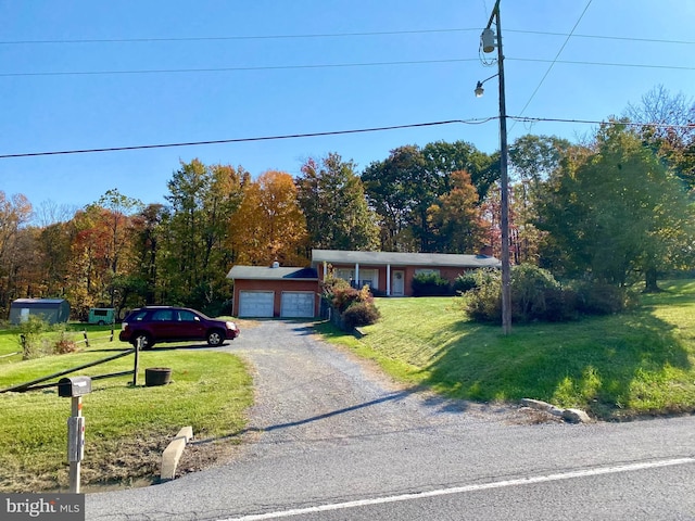 single story home featuring a garage and a front lawn