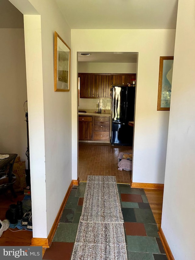 hallway with sink and dark wood-type flooring