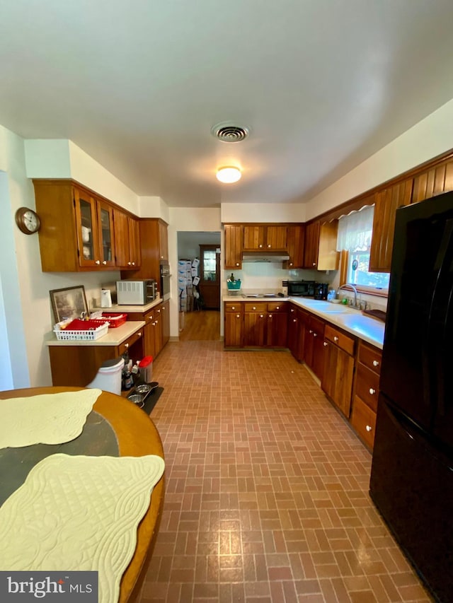 kitchen featuring black appliances and sink