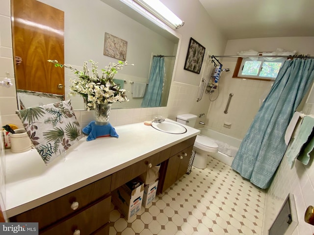 full bathroom featuring toilet, shower / bath combo, vanity, and tile walls