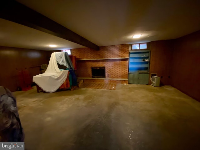 interior space featuring brick wall and a fireplace