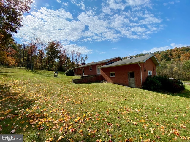 view of property exterior featuring a lawn