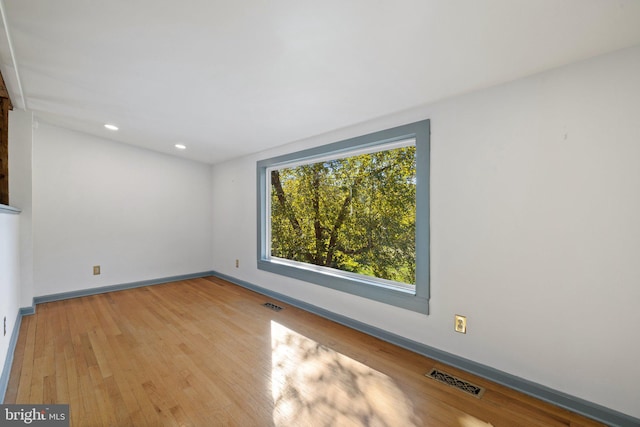 empty room with light hardwood / wood-style flooring