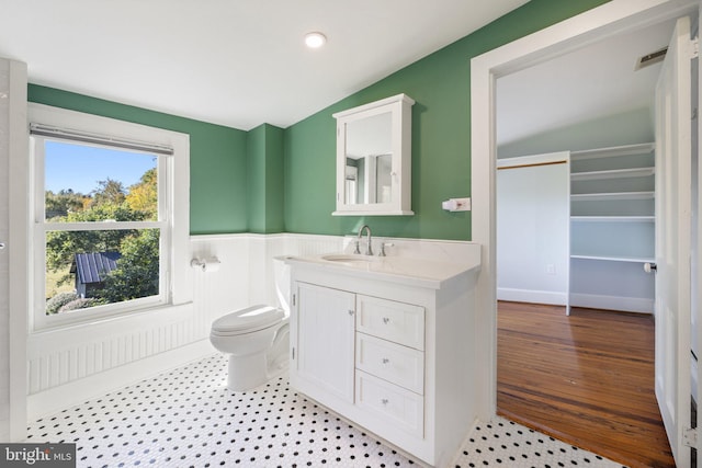 bathroom with toilet, a wainscoted wall, vanity, visible vents, and recessed lighting