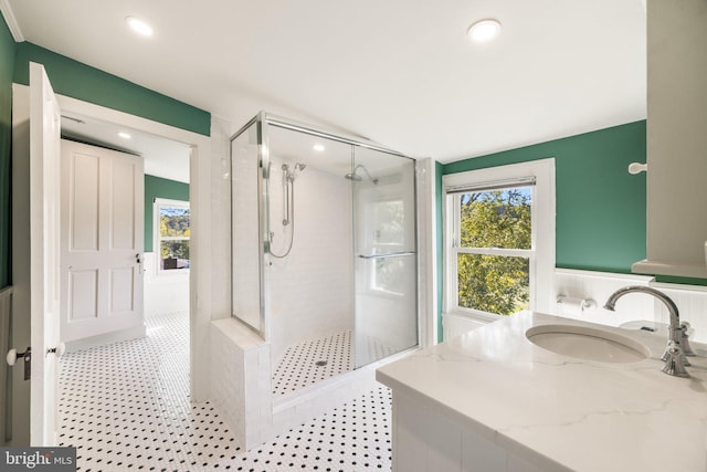 bathroom featuring a tile shower and vanity