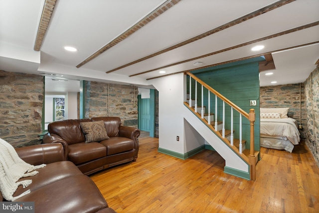 living room featuring hardwood / wood-style floors and beam ceiling