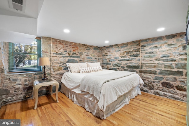 bedroom with visible vents, wood finished floors, and recessed lighting