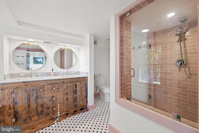 full bathroom featuring toilet, tiled shower, visible vents, and a sink