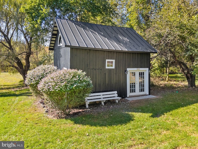 view of outbuilding featuring a yard