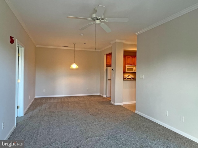 carpeted empty room featuring crown molding and ceiling fan