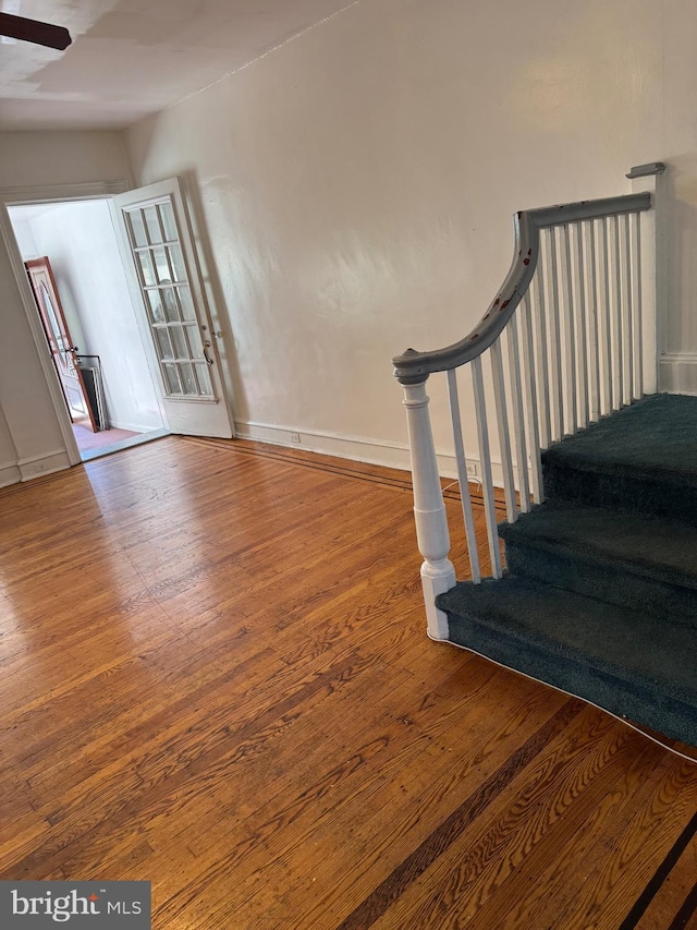 stairs featuring hardwood / wood-style floors