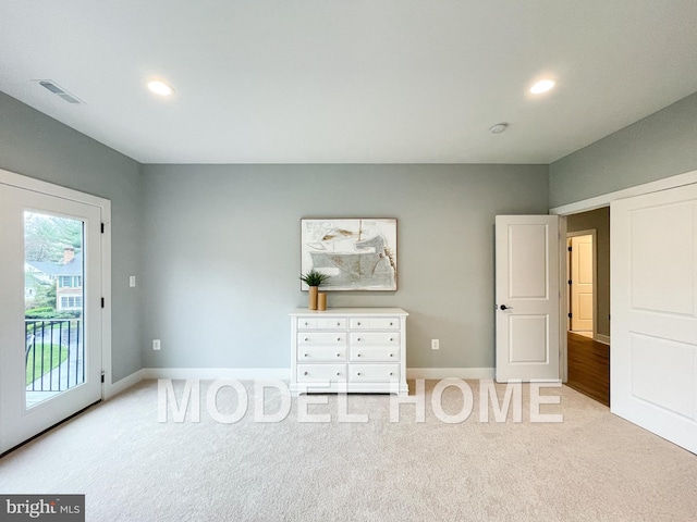unfurnished bedroom featuring access to outside, light carpet, visible vents, and recessed lighting