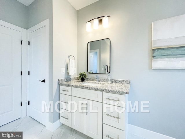 bathroom featuring marble finish floor, baseboards, and vanity