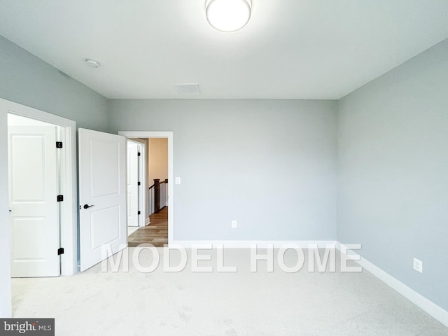 unfurnished bedroom featuring light colored carpet