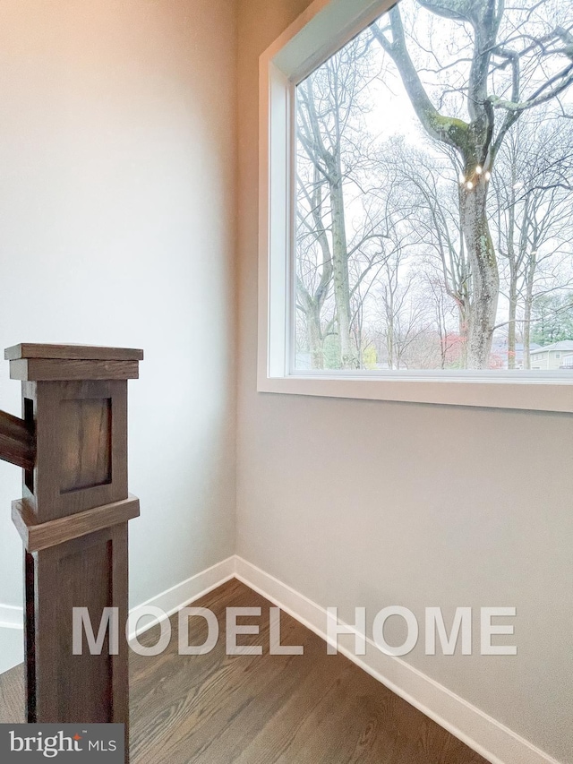 interior space with wood finished floors and baseboards