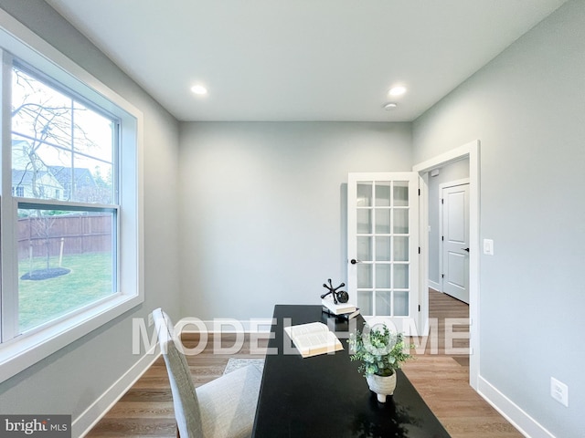 office area featuring recessed lighting, plenty of natural light, baseboards, and wood finished floors