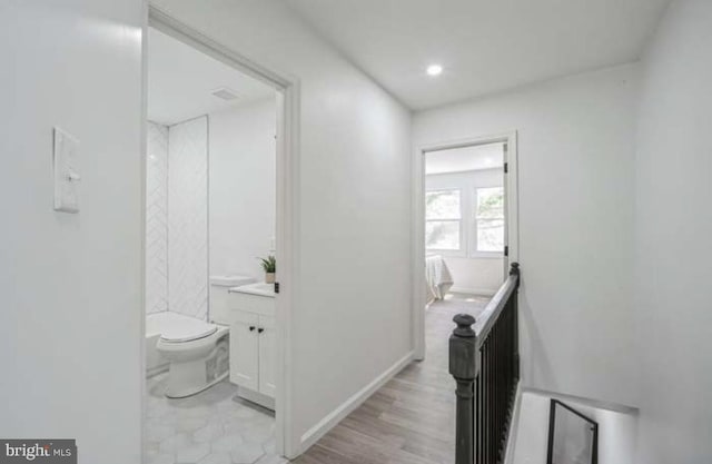 bathroom with vanity, toilet, and wood-type flooring