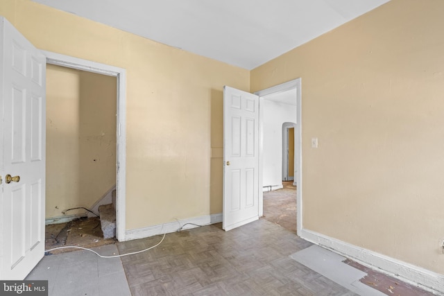 unfurnished bedroom with parquet flooring