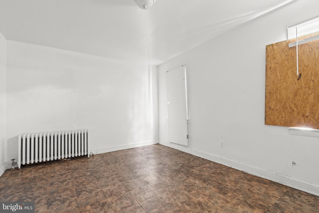 unfurnished room featuring radiator