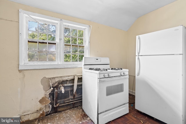 kitchen with dark wood-type flooring, white appliances, and vaulted ceiling