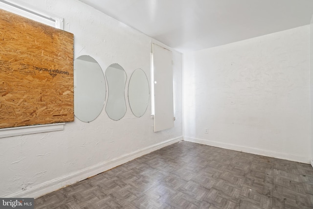 empty room featuring dark parquet flooring