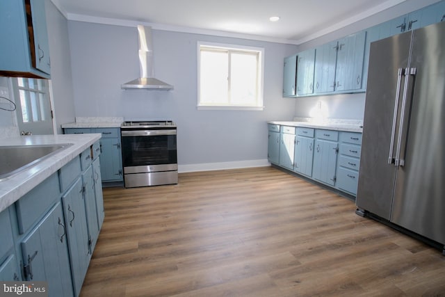 kitchen featuring stainless steel appliances, wall chimney exhaust hood, crown molding, and light hardwood / wood-style flooring