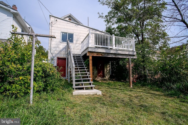 rear view of house with a lawn and a deck