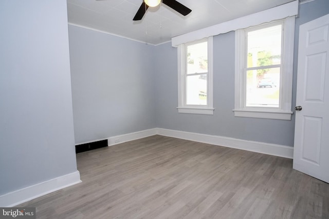 empty room featuring ceiling fan, crown molding, and light hardwood / wood-style floors