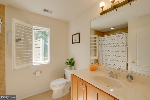 bathroom with curtained shower, tile patterned floors, vanity, and toilet