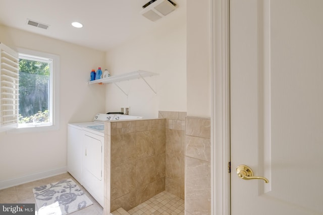 laundry area with washer / dryer and light tile patterned floors