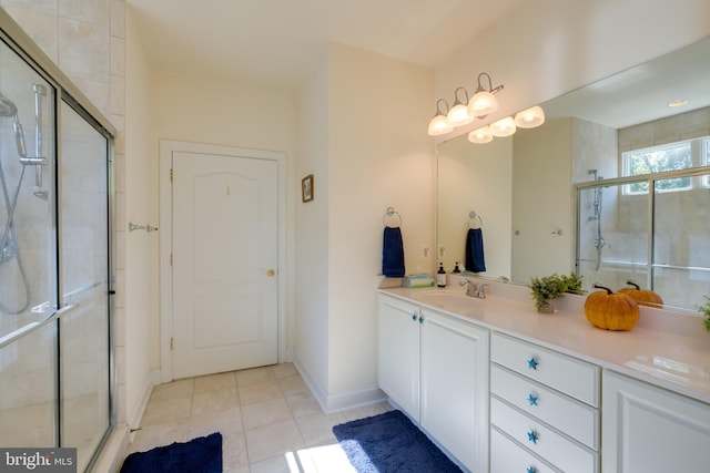 bathroom featuring tile patterned flooring, walk in shower, and vanity