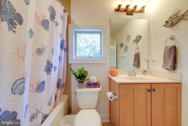 full bathroom with vanity, shower / tub combo with curtain, and toilet