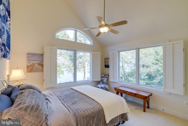 carpeted bedroom featuring high vaulted ceiling and ceiling fan