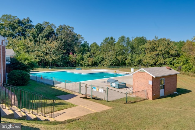 view of swimming pool featuring a yard and a patio area