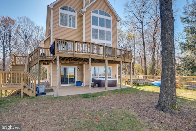 rear view of property with a yard, a patio area, and a deck