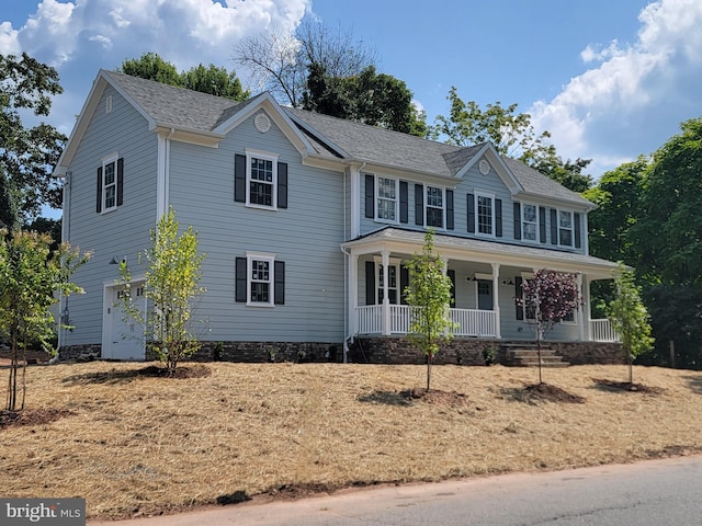 colonial inspired home featuring covered porch